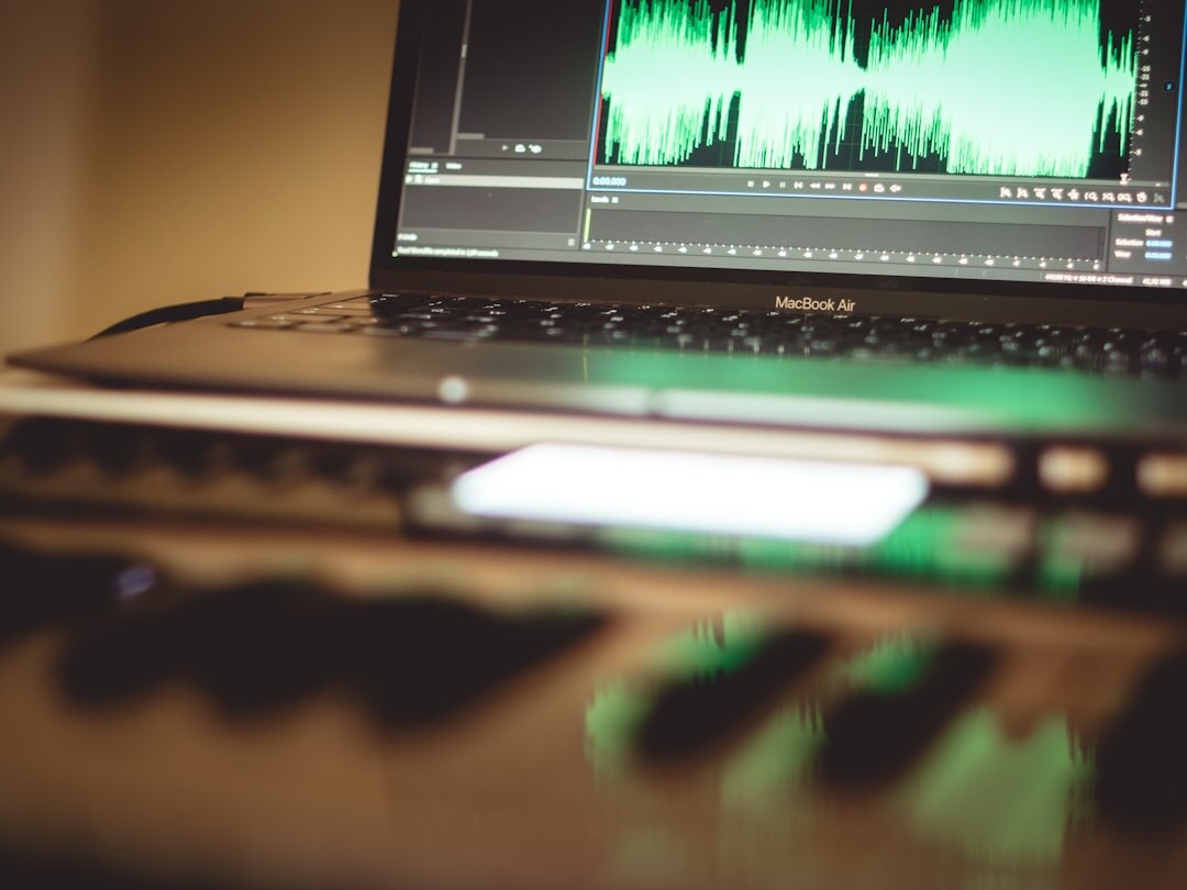 Editing a podcast episode's audio waveform on a laptop